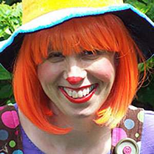 Cute clown with orange wig and wonderful smile