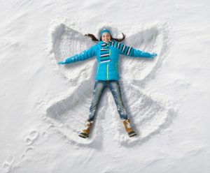 Girl making snow angel